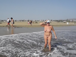 Adult woman shows her charms in the dunes