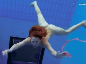 Curly hair redhead swims and looks sexy