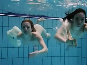 Nearly naked girls go swimming in the pool