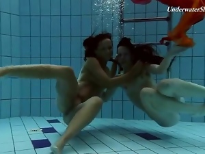 Two beautiful girls swim in the nude