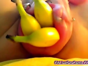horny brunette plays with bananas