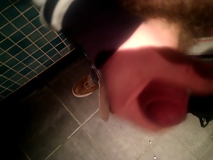 Wanking in a public toilet.