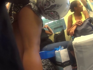 Short upskirt of girl with a helmet in hand inside the train